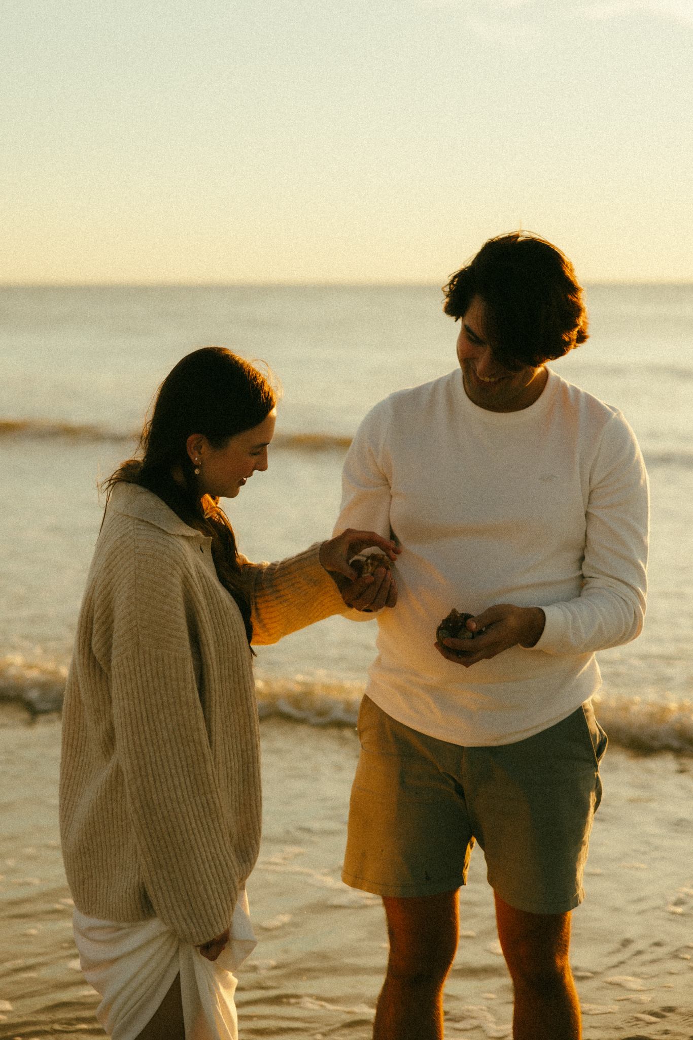 Couple holding seashells together. Documentary couples photo