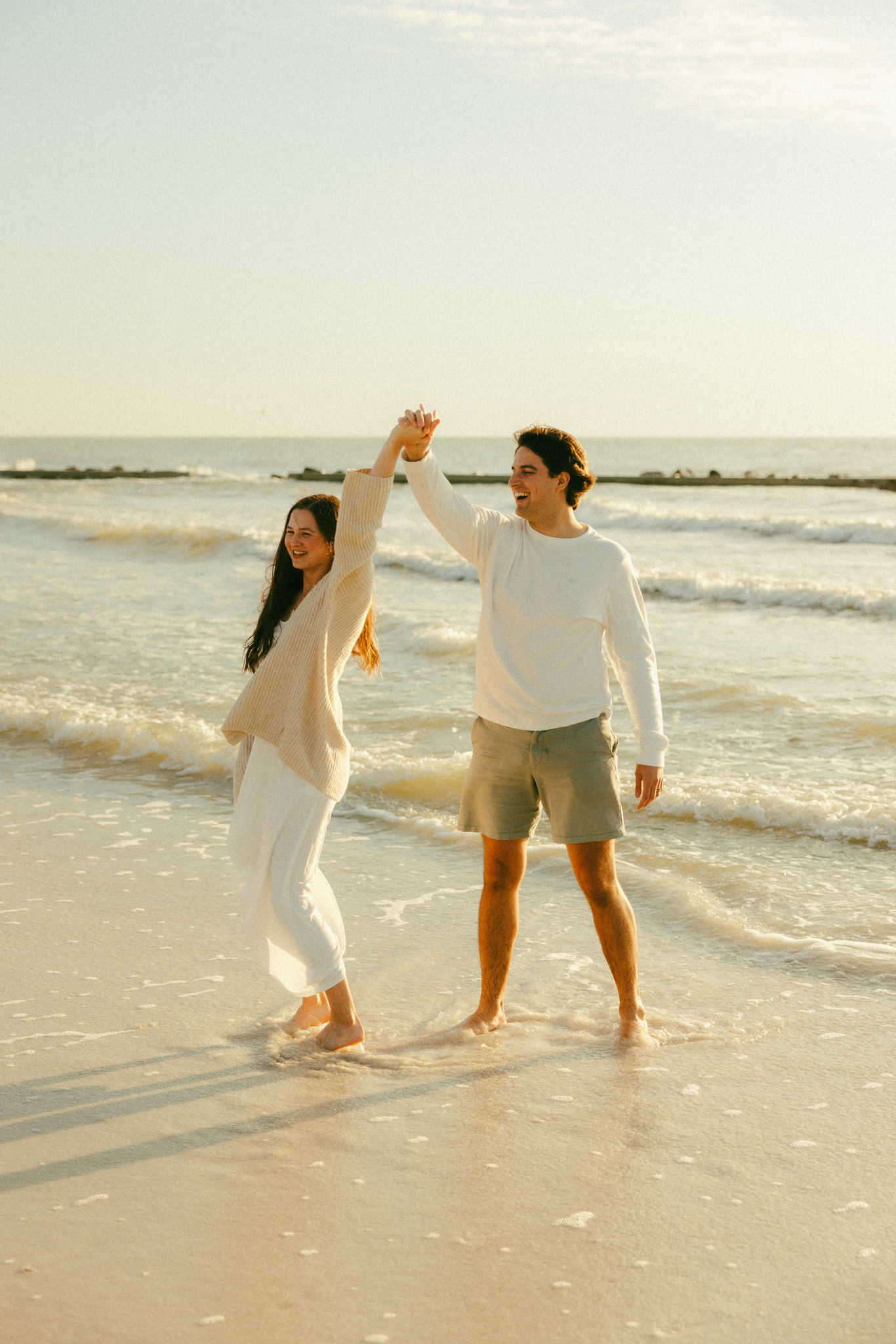 Couple laughing at Honeymoon Island State Park Beach couples photo session.