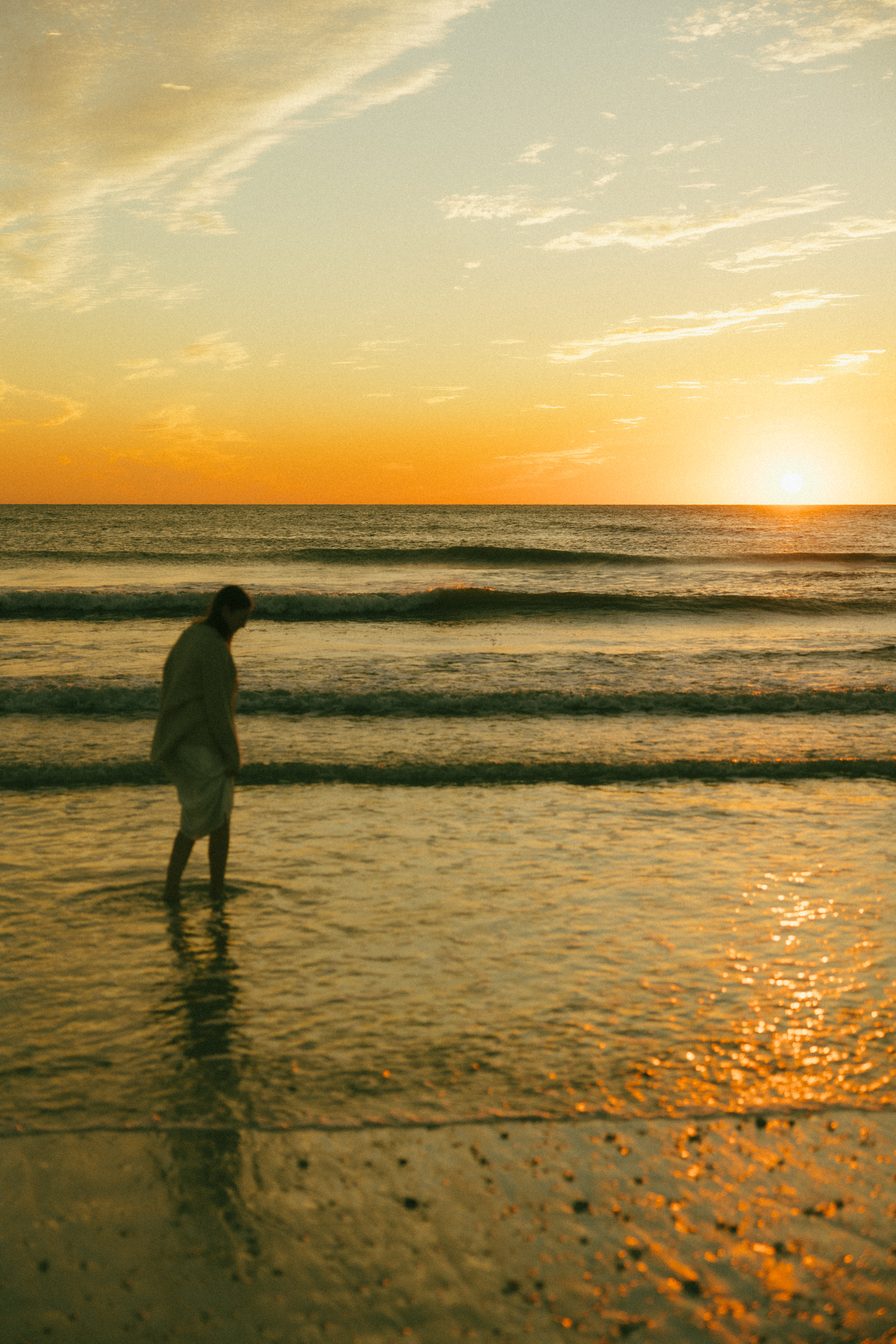 Golden sunset silhouette portrait of woman on Florida beach