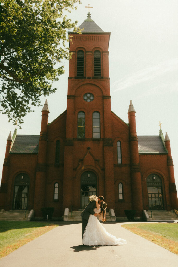 Choosing your wedding venue. Couple kissing outside church