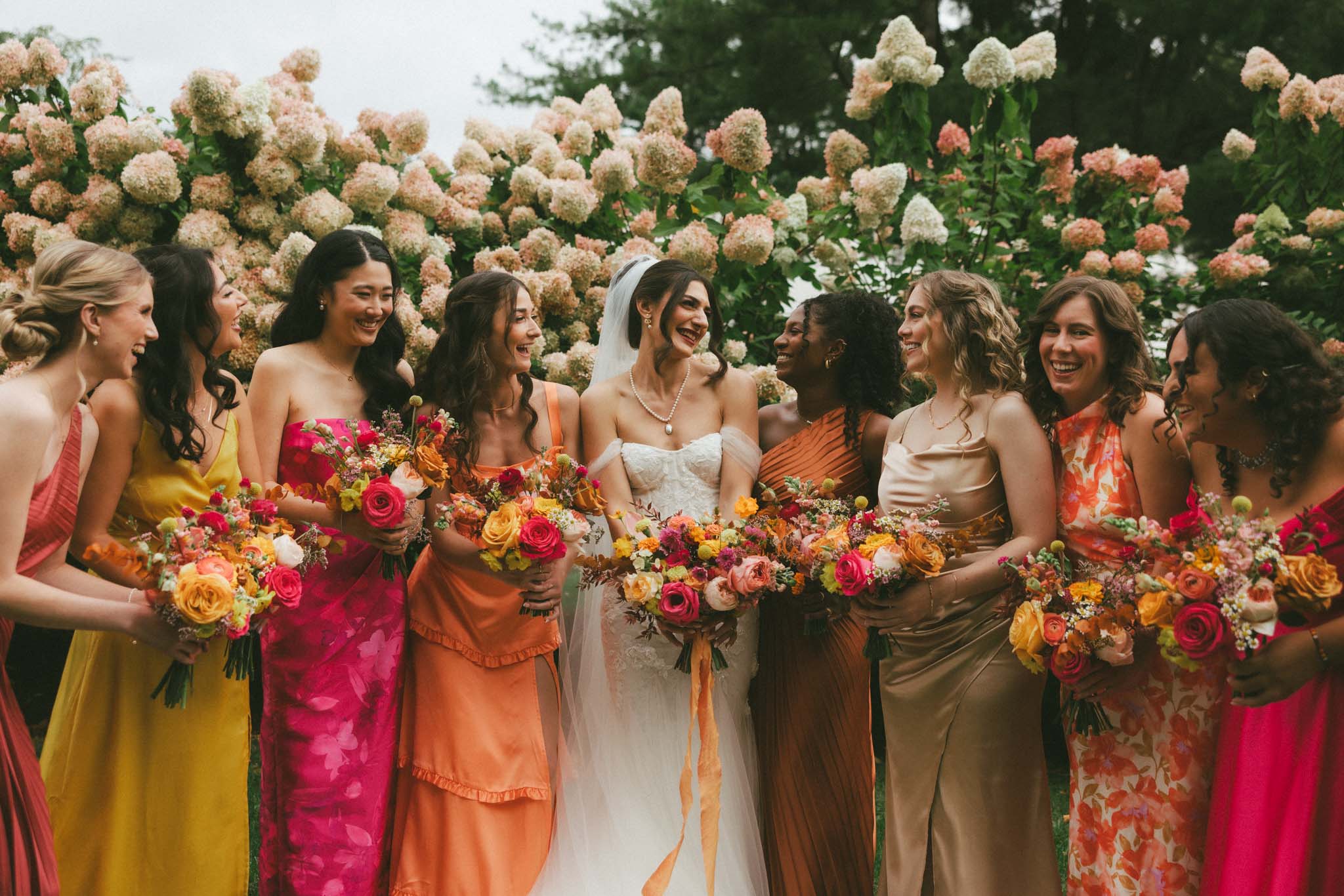 Bride with bridesmaids with hot pink, yellow, and orange theme