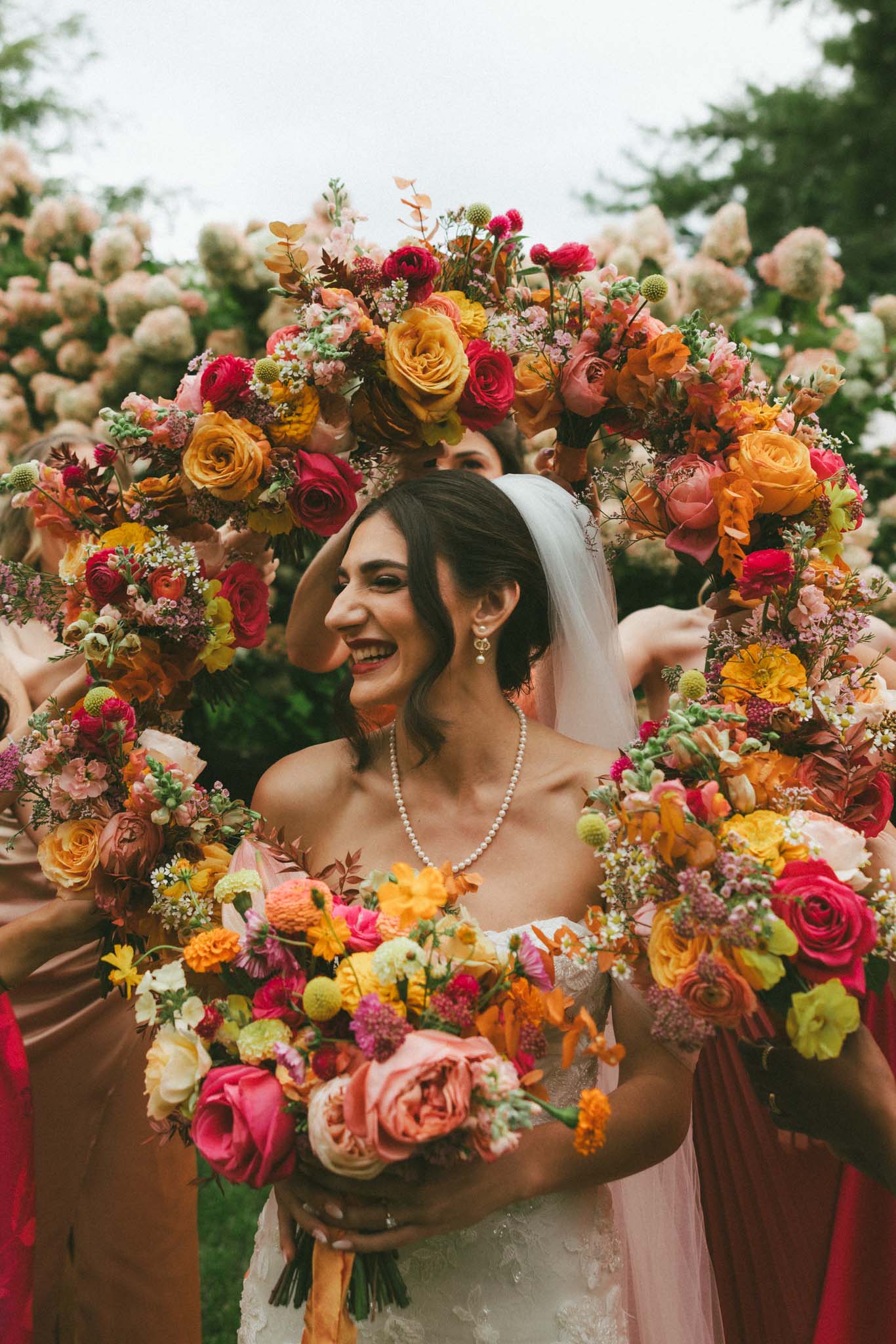 Bride with hot pink, yellow, and orange flowers