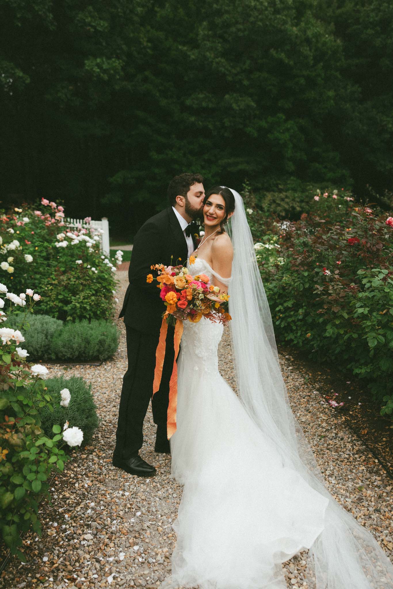 Bride and groom in rose garden