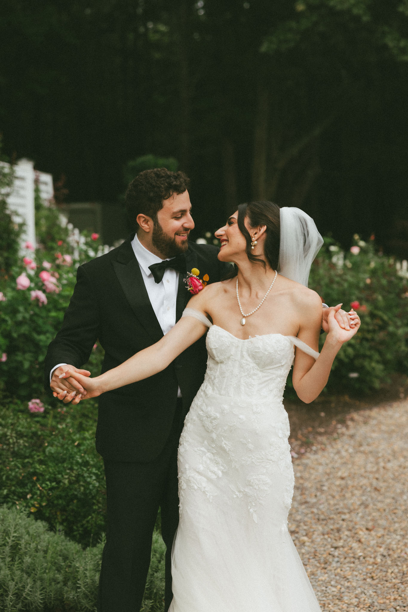 Bride and groom in rose garden