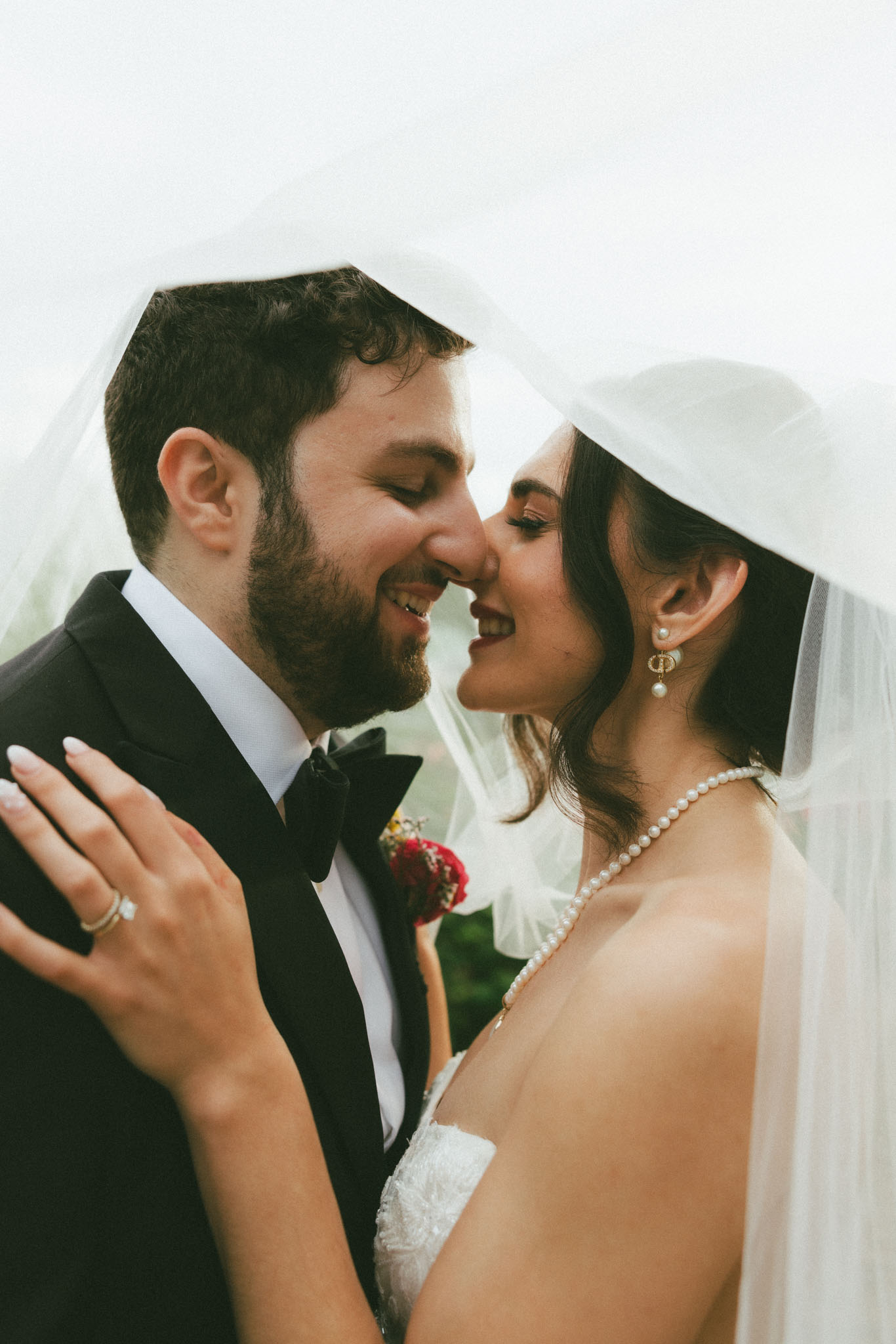 Bride and groom under veil