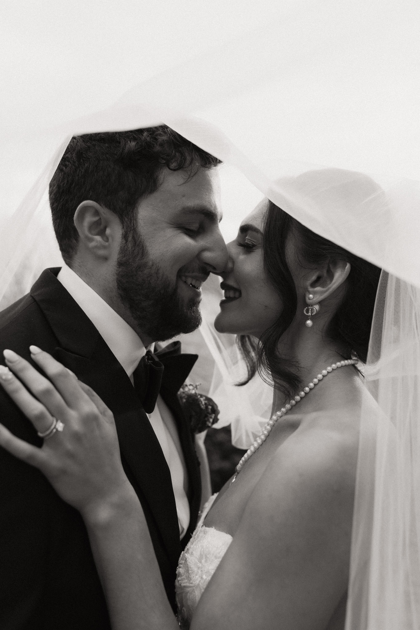 Bride and groom under veil black and white