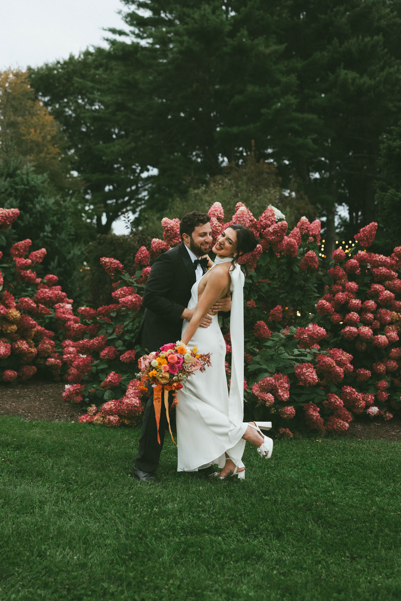 Bride and groom in garden smiling