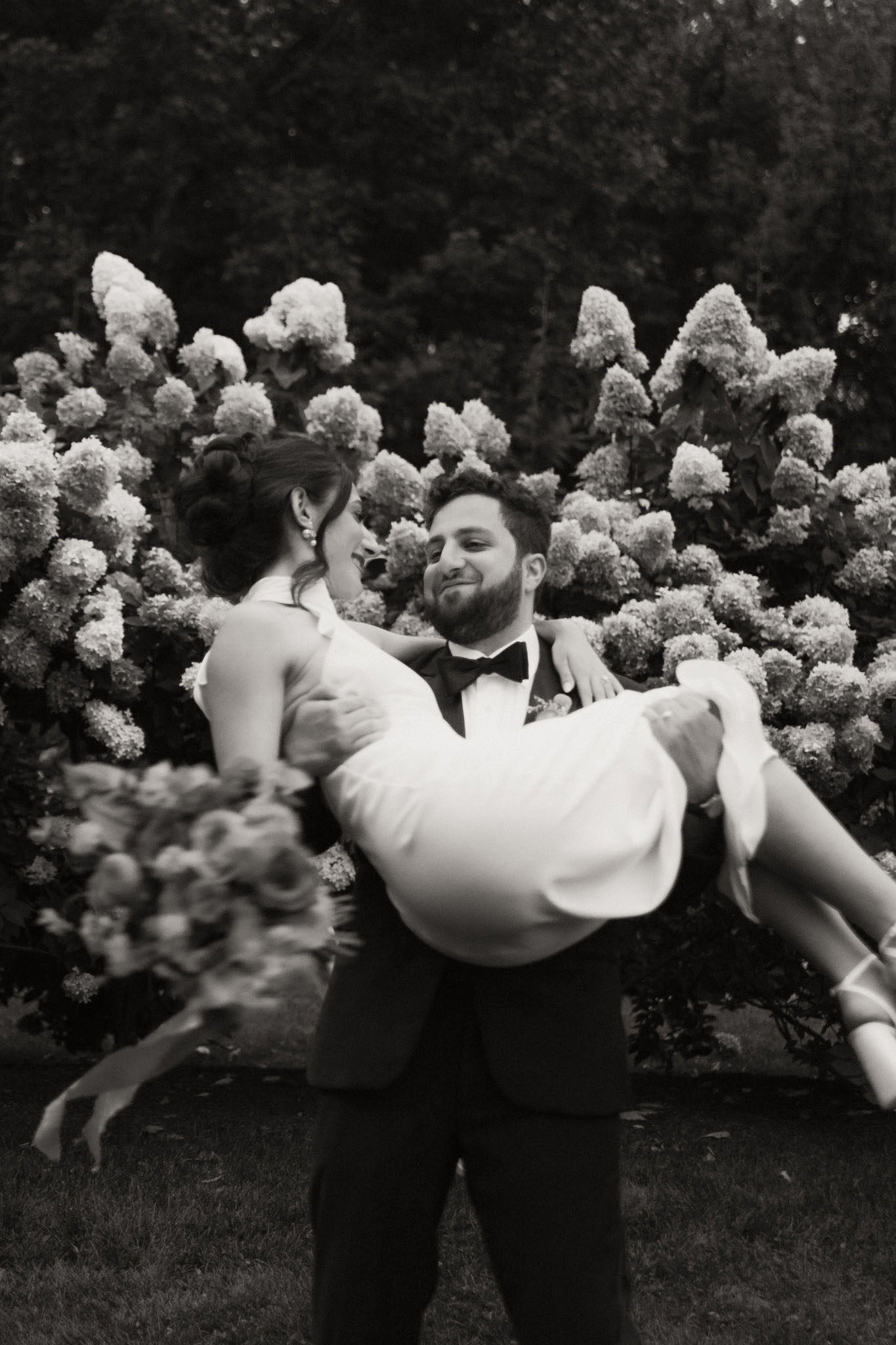 Bride and groom garden black and white